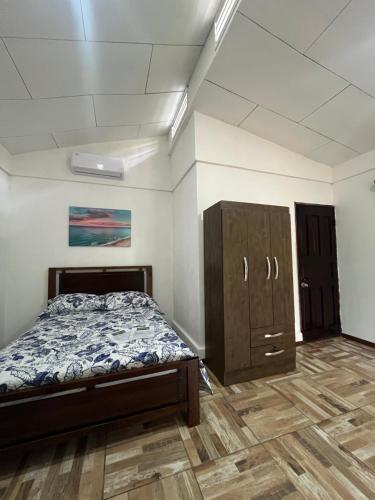 an empty room with a bed and a cabinet at Secret Paradise in Cocles