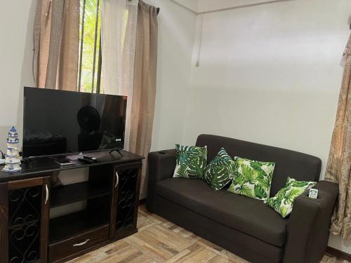 a living room with a couch and a flat screen tv at Secret Paradise in Cocles