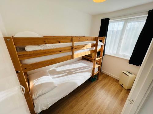 two bunk beds in a room with a window at 2 Bedroom Chalet SB177 Sandown Isle of Wight in Brading