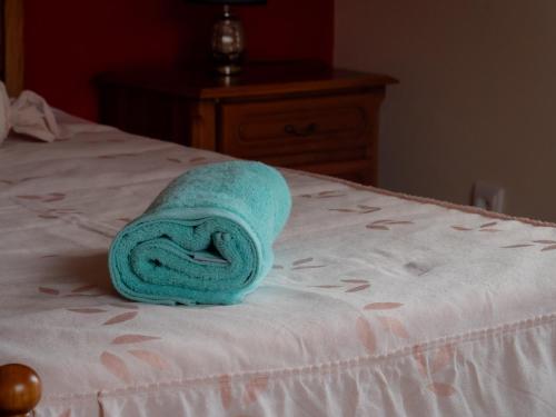 a towel is sitting on top of a bed at The House of Passos in Ponta do Sol