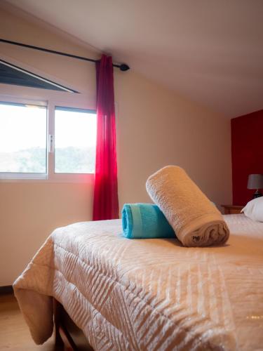 a bedroom with a bed with a towel on it at The House of Passos in Ponta do Sol