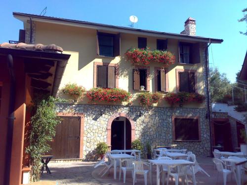 a building with tables and chairs in front of it at Azienda Agrituristica Salella in Salento