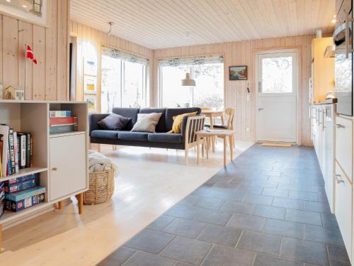 a living room with a couch and a table at 5 person holiday home in Dannemare-By Traum in Dannemare
