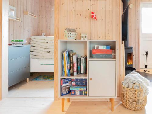 a book shelf filled with books in a room at 5 person holiday home in Dannemare-By Traum in Dannemare
