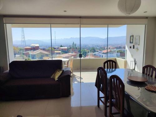 a living room with a table and a couch at Departamento con excelente vista de la ciudad in Tarija