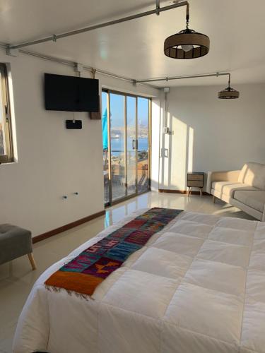 a large bed in a room with a large window at Loft la herradura in Coquimbo