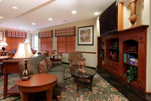 a living room with a couch and a flat screen tv at Residence Inn by Marriott Oklahoma City South in Oklahoma City