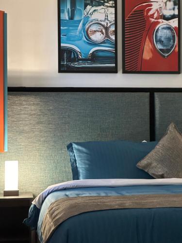 a bedroom with a bed with three pictures on the wall at Beta Hotel in Salento
