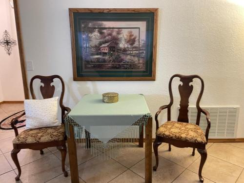 a dining room with a table and two chairs at Cozy house centrally located close to everything in NWA in Springdale