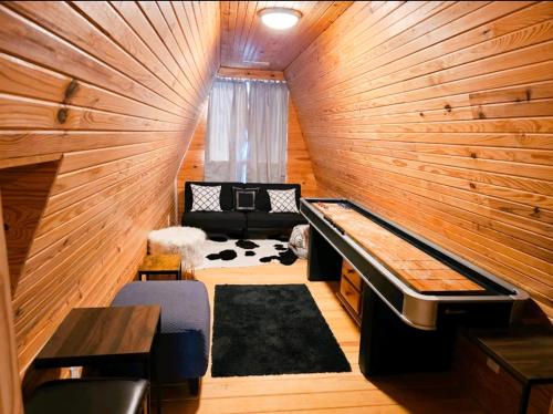 a small room with a piano in a wooden wall at Beaver Lake Hideaway in Lowell