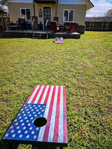 an american flag rug on the grass in front of a house at Beaver Lake Hideaway in Lowell