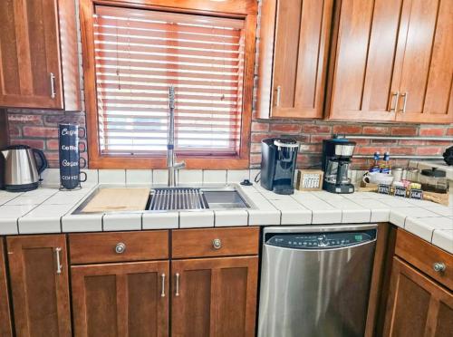 a kitchen with a sink and a dishwasher at Beaver Lake Hideaway in Lowell