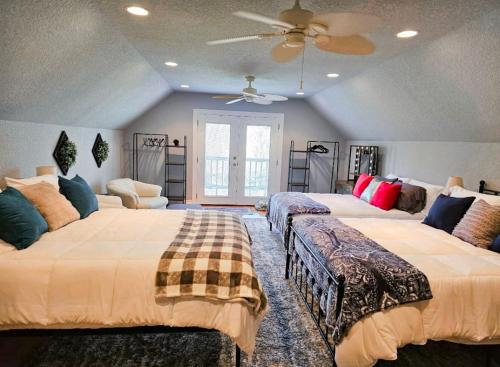 a bedroom with two beds and a ceiling fan at Beaver Lake Hideaway in Lowell