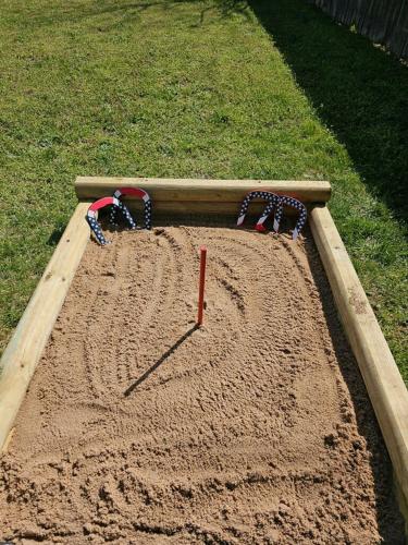 a sandpit with a play area with goggles in it at Beaver Lake Hideaway in Lowell