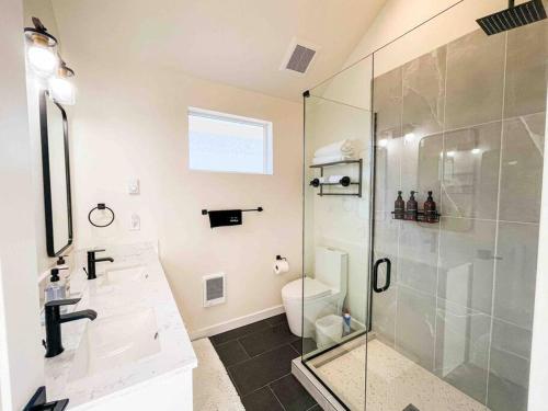 a bathroom with a glass shower and a toilet at Central Seattle Peaceful Private Retreat 10 Mins Walk From Groceory Store in Seattle