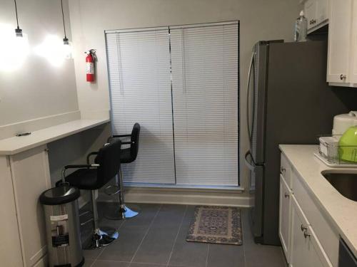 a kitchen with a chair and a window with blinds at Entire Twnhouse 2bdrms 3Bthrm 2Qbeds 2Levls Fncd Bkyard in Greenbelt