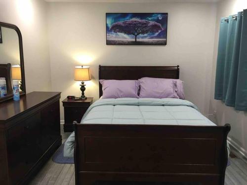a bedroom with a bed with a tree on the wall at Entire Twnhouse 2bdrms 3Bthrm 2Qbeds 2Levls Fncd Bkyard in Greenbelt
