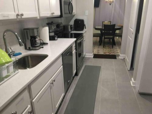 a kitchen with a sink and a counter top at Entire Twnhouse 2bdrms 3Bthrm 2Qbeds 2Levls Fncd Bkyard in Greenbelt