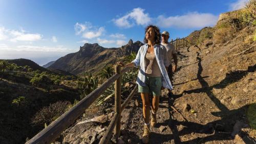 a woman walking on a trail in the mountains at Casa Luisa Atico - Vallehermoso Centro Casco Antiguo in Vallehermoso