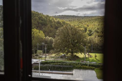 a view of a tree from a window at Sotto Il Cielo Hotel in Pignola