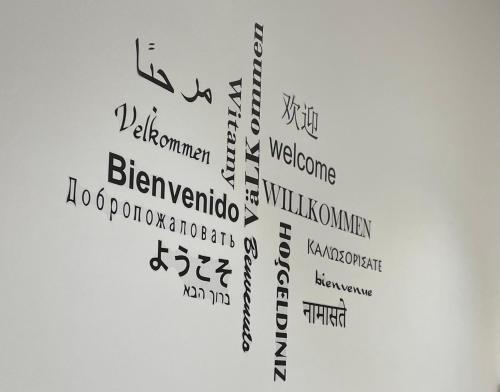 a collage of music words on a white wall at Carte du Monde by ARoom VUT-LE-967 in León