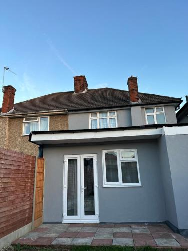 a white house with a brick at Self-contained en-suite room very close to Wembley stadium in London