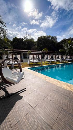 a group of chairs sitting next to a swimming pool at Verde Mar Pipa Beach in Pipa