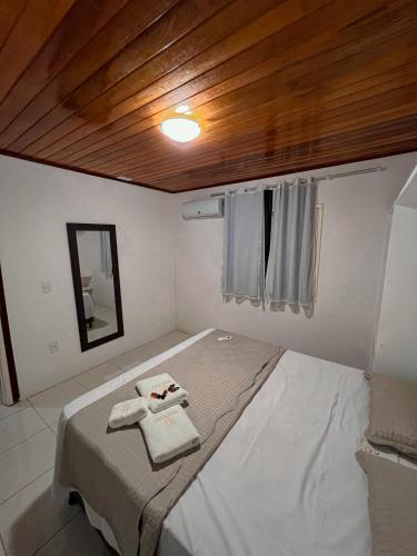 a bedroom with a bed with a wooden ceiling at Verde Mar Pipa Beach in Pipa