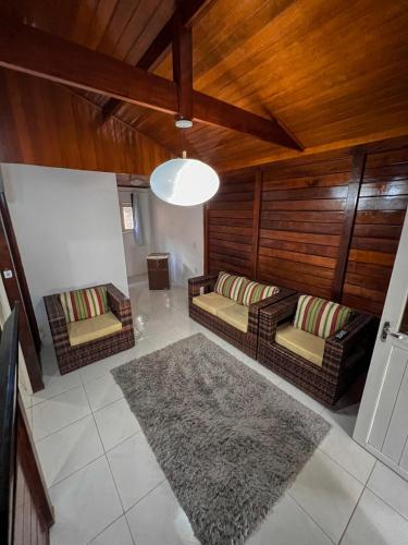 a living room with two couches and a rug at Verde Mar Pipa Beach in Pipa
