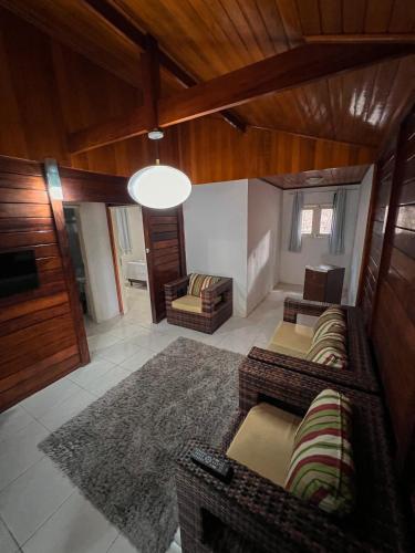 a living room with two couches and a rug at Verde Mar Pipa Beach in Pipa