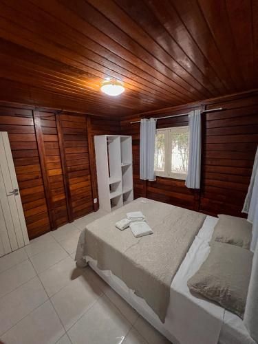 a bedroom with a bed and a wooden ceiling at Verde Mar Pipa Beach in Pipa