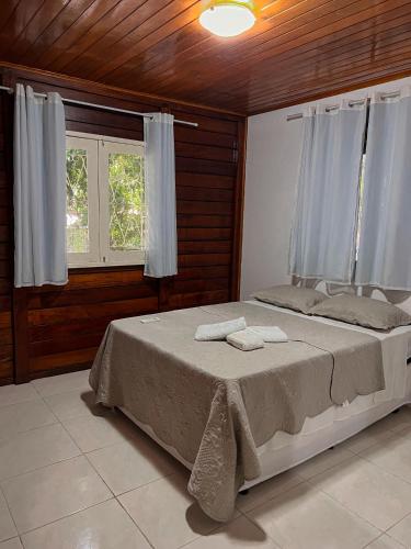 a bedroom with a bed with two towels on it at Verde Mar Pipa Beach in Pipa