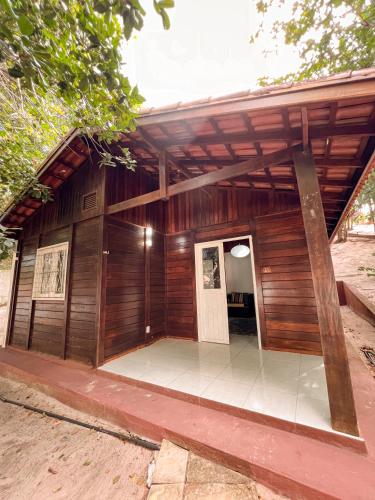 a wooden building with a door and a porch at Verde Mar Pipa Beach in Pipa