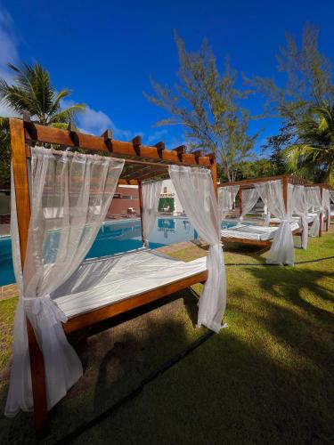 a row of beds lined up next to a pool at Verde Mar Pipa Beach in Pipa