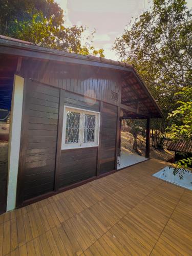 a house with a garage with a wooden deck at Verde Mar Pipa Beach in Pipa