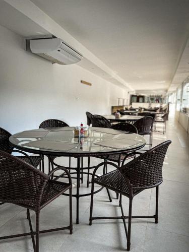 a group of tables and chairs in a room at Verde Mar Pipa Beach in Pipa