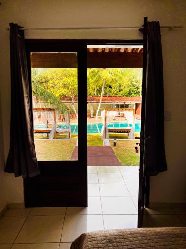 an open door with a view of a pool at Verde Mar Pipa Beach in Pipa