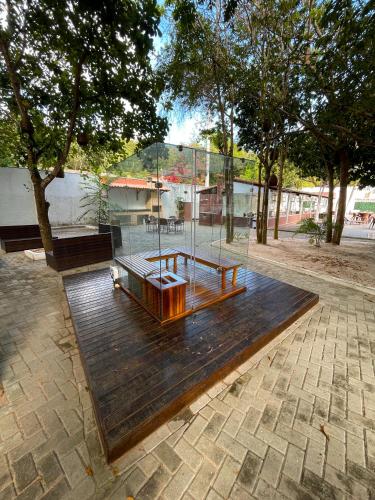a bench and a table on top of a wooden floor at Verde Mar Pipa Beach in Pipa
