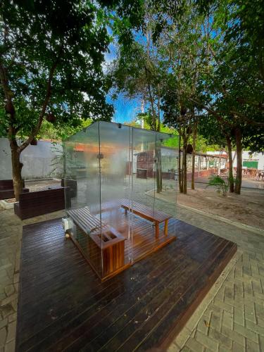 a glass building with a bench in a park at Verde Mar Pipa Beach in Pipa