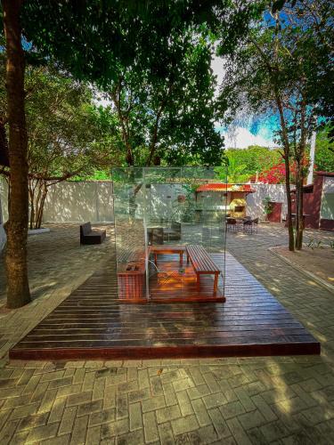 a glass building with a bench in a park at Verde Mar Pipa Beach in Pipa