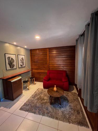 a living room with a red couch and a table at Verde Mar Pipa Beach in Pipa