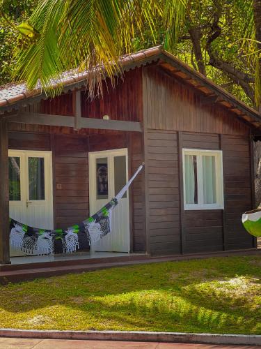 a house with a hammock in front of it at Verde Mar Pipa Beach in Pipa