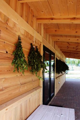 a wooden building with plants on the wall at Bojarski Gościniec in Narewka