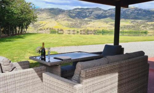 a patio with a table and an umbrella at Lakeside Retreat in Cromwell
