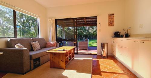 a living room with a couch and a table at Lakeside Retreat in Cromwell