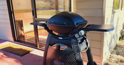 a grill sitting on the porch of a house at Lakeside Retreat in Cromwell