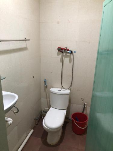 a bathroom with a toilet and a shower at Hotel Sekawan in Jodoh