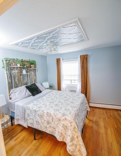 a bedroom with a large bed with a white comforter at Brooklyn Double Decker in Brooklyn