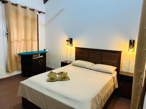 a bedroom with a bed with a bow on it at Departamento 2 habitaciones Trinidad Beni in Trinidad