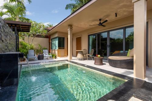 a swimming pool in the backyard of a house at De Malee Pool Villas in Ao Nang Beach